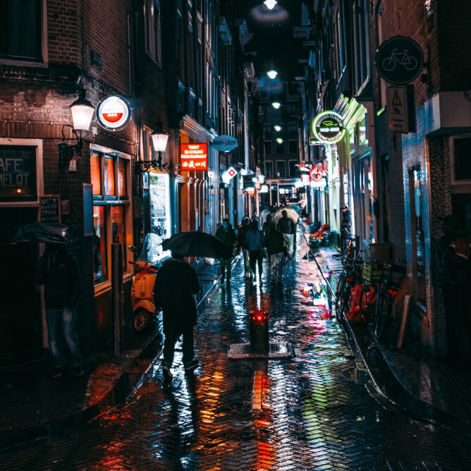 A shot of a rainy Amsterdam street in the dark