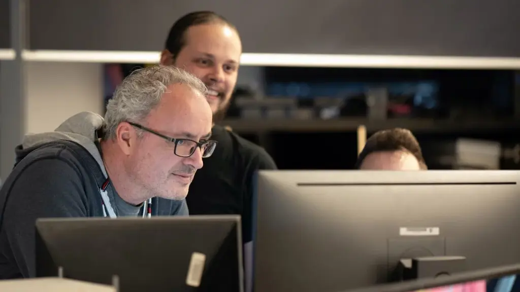 Two team members working together at a computer